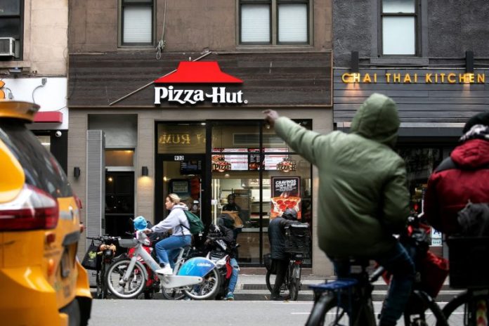 Yum Brands said on Tuesday it was exploring strategic options for its Pizza Hut chain as the unit struggles to keep pace in a highly competitive fast-food industry vying for sales from a stressed consumer.
“Pizza Hut‘s performance indicates the need to take additional action to help the brand realize its full value, which may be better executed outside of Yum Brands,” Yum Brands’ new CEO, Chris Turner, said in a statement.
Pizza Hut‘s sales have lagged Yum Brands’ other prominent units, Taco Bell and KFC International, falling for seven consecutive quarters. In comparison, Taco Bell last reported negative comparable sales in June 2020.
Yum Brands’ shares were up about 2% in premarket trading after the company banked on 7% growth in Taco Bell U.S. same-store sales and 3% growth in KFC International to beat third quarter estimates.
Pizza Hut accounts for about 11% of Yum Brands’ operating profits, compared with about 38% for Taco Bell’s U.S. business.
Several quarters of price hikes at restaurants, sticky inflation and economic uncertainty have forced consumers to become more wary about dining out as they look to stretch their budgets. Still, pizzas are viewed as a value-option to feed families.
Industry giant Domino’s Pizza DPZ.O said in October that although fast-food traffic was slowing, consumers were still seeking out its pizzas, helped by promotions and new menu items, as well as its delivery partnerships with third-party aggregators such as Doordash DASH.O and UberEats UBER.N.
While Pizza Hut has also offered value deals such as various personal pizzas for $5 and $2, “an insufficient value message amid a competitive value landscape resulted in transaction softness,” company veteran and former CEO David Gibbs said in August.
Taco Bell’s Tex-Mex cuisine and its more affordable prices have held Yum Brands in good stead against the slowdown in dining out.
Yum Brands’ worldwide same-store sales grew 3% during the quarter ended September 30, 2025 edging past estimates of a 2.68% increase, according to data compiled by LSEG.
Adjusted profit per share of $1.58 beat estimates of $1.49.
Packaged food giant PepsiCo acquired Pizza Hut in 1977, but spun off the chain along with KFC and Taco Bell in 1997 to create a restaurants company, which took on the name Yum Brands in 2002.
A deadline to complete Pizza Hut‘s strategic review has not been set, and there was no assurance that the process would result in a transaction, Yum Brands said on Friday.
This post appeared first on NBC NEWS