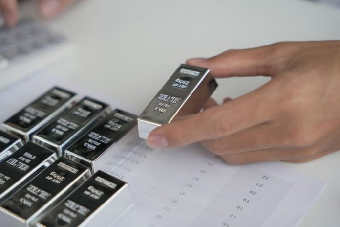 <strong>Investing in silver futures is one of many options for those interested in entering the silver market.</strong>
The highest price for silver to date was reached half a century ago, when the precious metal hit US$48.70 per ounce. With the silver price hitting US$44 per ounce following the US Federal Reserve’s September 2025 rate cut, investors are wondering if the white metal will it break past its record. Some silver bulls believe that could happen in the near future, with a few market insiders even calling for a triple-digit silver price.
Trading silver futures is not the same as owning physical bullion, but it’s a popular strategy for advanced investors with a higher risk tolerance. Read on to learn more about how silver futures work and what role they can play in a portfolio.
What are silver futures?
Silver futures trading involves an agreement between a buyer and a seller in which physical silver will be bought by the buyer and delivered by the seller for a fixed price at a date set in the future.
Most traders (especially short-term traders) aren’t concerned about delivery when it comes to silver futures — they typically use cash to settle their long or short positions before they expire or defer them to the next available delivery month. Overall, very few silver futures contracts traded each year actually result in the delivery of the underlying commodity.
What exchanges are silver futures traded on?
Silver futures can be traded on various global exchanges, but the COMEX is a common option. The COMEX is one of four exchanges that make up CME Group, which bills itself as the world’s leading derivatives marketplace.
On the COMEX, monthly silver futures contracts are listed for the current calendar month or the following two calendar months, plus any January, March, May or September within a 23 month period. July and December are also included should they fall within a 60 month period, beginning with the current month. The material offered must assay to a minimum of 999 fineness.
According to Investopedia, silver futures on the COMEX are quoted in US dollars per troy ounce and are traded in units of various sizes, ranging from 1,000 (known as micro contracts) to 2,500 (E-mini contracts) to 5,000 (full contracts) troy ounces. For example, a price quote of US$24 for 5,000 troy ounces would cost approximately US$120,000.
In the case of a full contract, investors who wait for their silver futures to mature will either receive or deliver a 5,000 troy ounce COMEX silver warrant for a full-sized silver future, depending on if they are the buyer or the seller. One warrant entitles the holder to ownership of equivalent bars of silver in designated depositories, such as with the The Brink’s Co (NYSE:BCO), HSBC Holdings (NYSE:HSBC, LSE:HSBA), Manfra Tordella & Brookes, Delaware Depository and JPMorgan Chase & Co. (NYSE:JPM).
The COMEX settlement process is different for smaller silver futures contracts.
Silver futures are also traded electronically on the Indian National Commodity & Derivatives Exchange (NCDEX), the Dubai Gold & Commodities Exchange (DGCX), the Multi Commodity Exchange of India (MCX) and the Tokyo Commodity Exchange (TOCOM).
Why invest in silver futures?
Silver typically follows in the footsteps of gold and is considered a safe-haven asset. Investors tend to flock to precious metals in times of turmoil, which bumps up demand, and if gold is too expensive, silver is a cheaper option.
Futures offer a limit on potential losses to buyers, which attracts those interested in hedging. Hedgers such as producers, portfolio managers and consumers often use futures to mitigate price risk — their goal is to protect themselves from inflation and to reap the rewards of favorable price movements. On the flip side, speculative investors can use silver futures to gain exposure to the white metal while only putting up a fraction of the total cost for a contract.
Of course, silver has equal potential to suffer large losses in the futures market — due to the leverage involved, investors can lose funds in their accounts quickly. For that reason, experts often encourage inexperienced market participants to avoid the futures market until they have a good idea of their desired risk profile, time horizon and cost considerations.
<strong>Securities Disclosure: I, Melissa Pistilli, hold no direct investment interest in any company mentioned in this article.</strong>
This post appeared first on investingnews.com